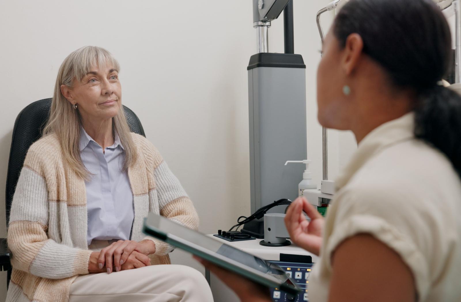 A senior person talking to an optometrist about their options for dry eye treatment